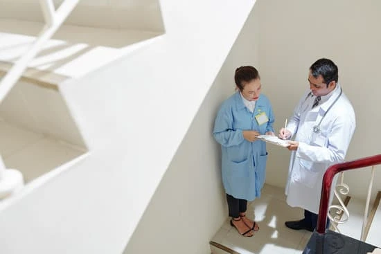 doctor signing document at stairwell